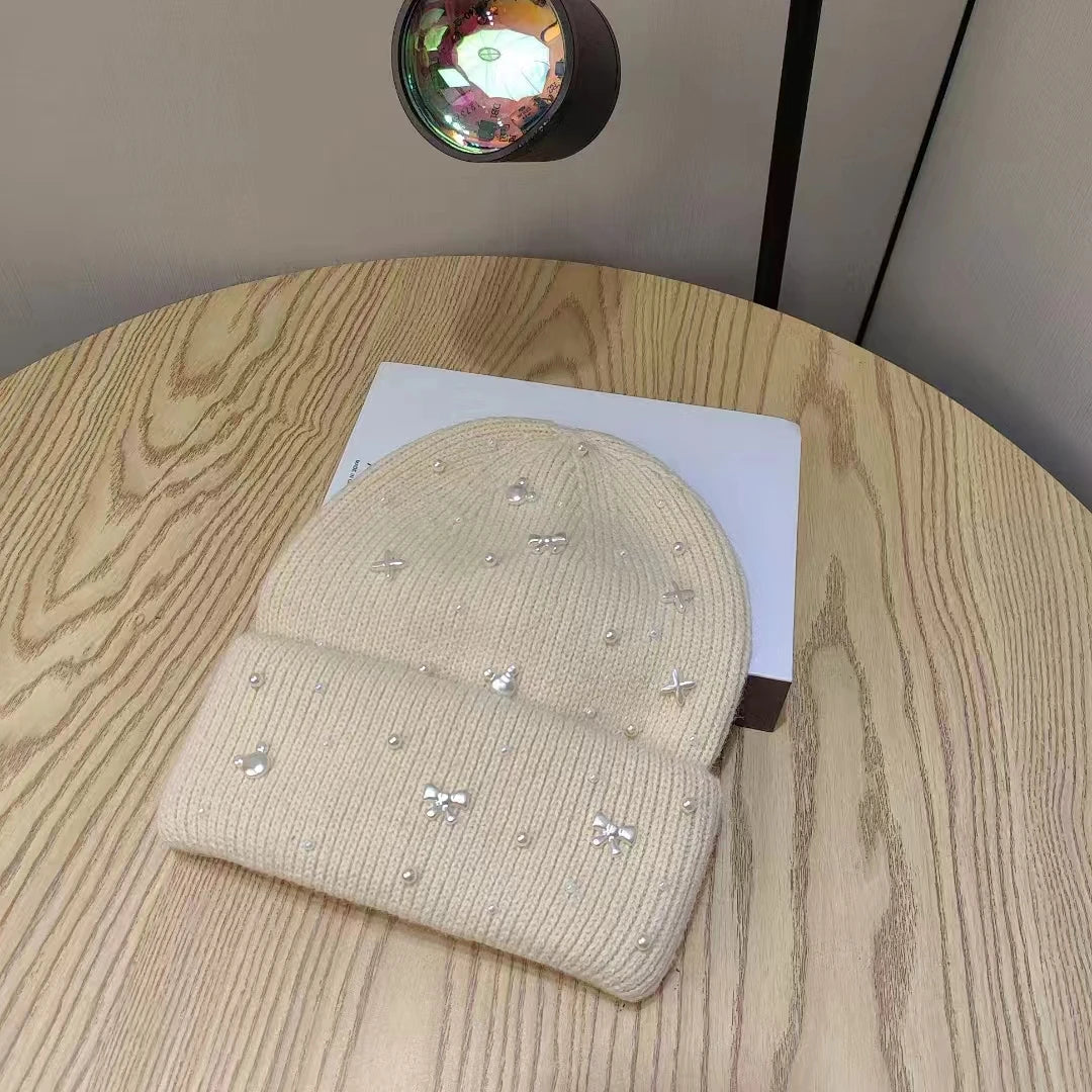 Beige Belro Pearl Accent Knit Beanie winter hat with pearl embellishments, cozy knit fabric, stylish winter accessories.