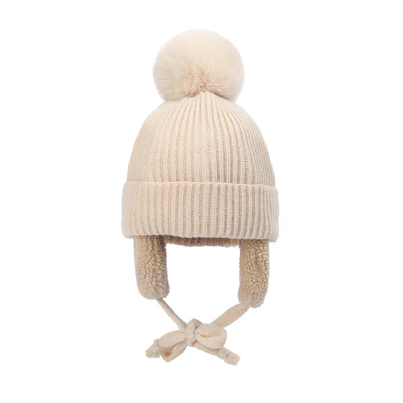 Beige kids knit beanie winter hat with earflaps and pom-pom, Belro brand, cozy accessories for cold weather.