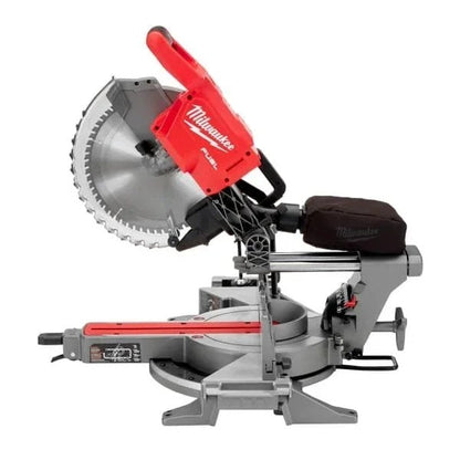 Milwaukee 18V lithium-ion cordless 12-inch dual bevel sliding compound miter saw on a workbench with a cutting blade and adjustable angles.