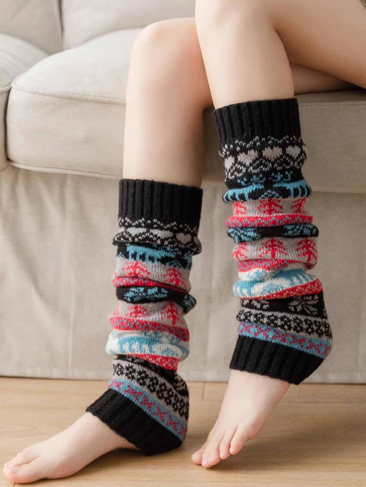 Black cozy knit leg warmer by Belro, perfect for fall and winter, shown on a model's legs for warmth and style.