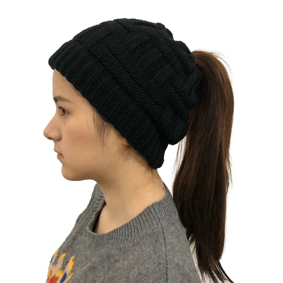 Black women’s winter knit beanie hat with a built-in ponytail opening, by Belro, designed for cold weather and stylish warmth.