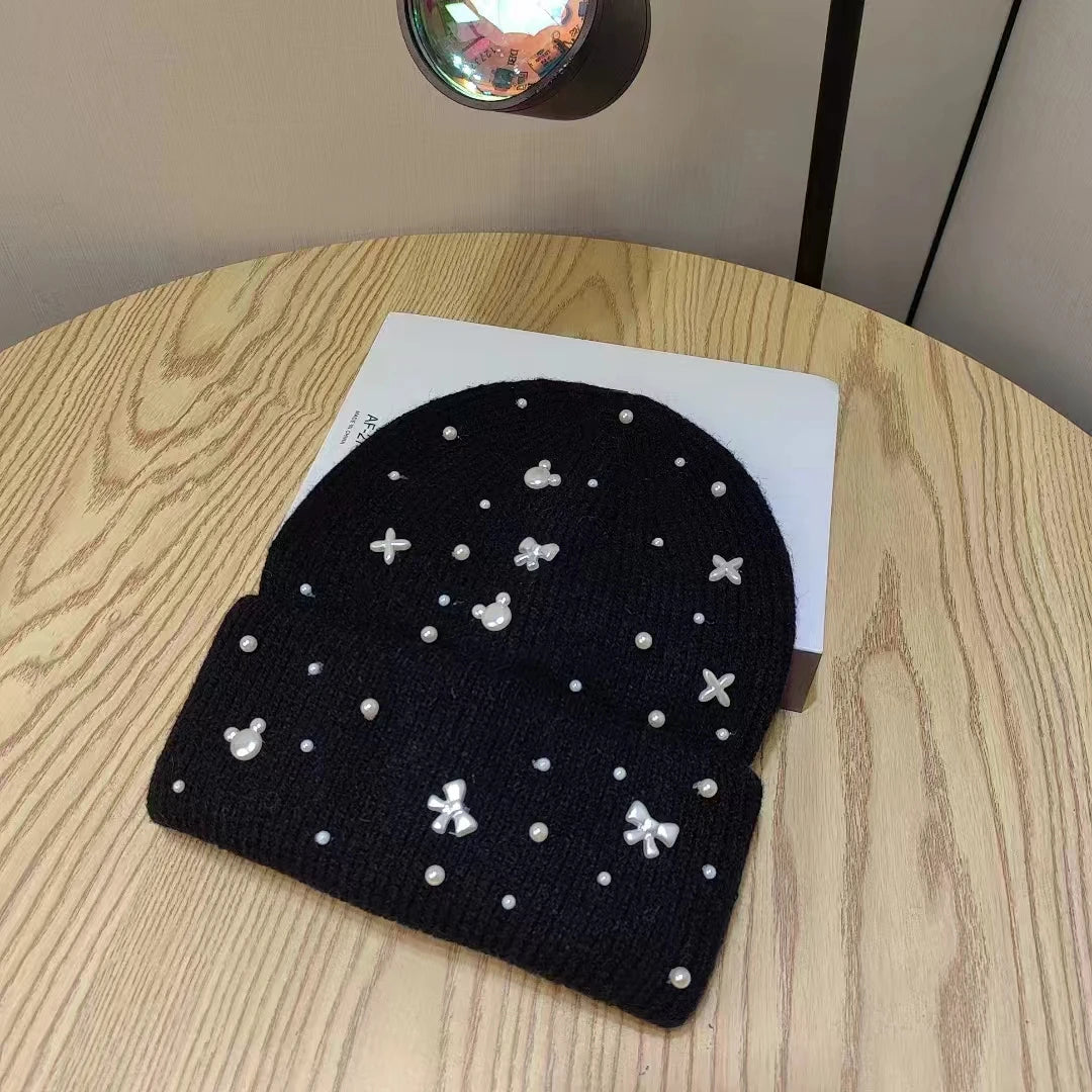 Black Belro knit beanie with pearl accents, winter hat featuring a cozy, stylish design for cold weather.