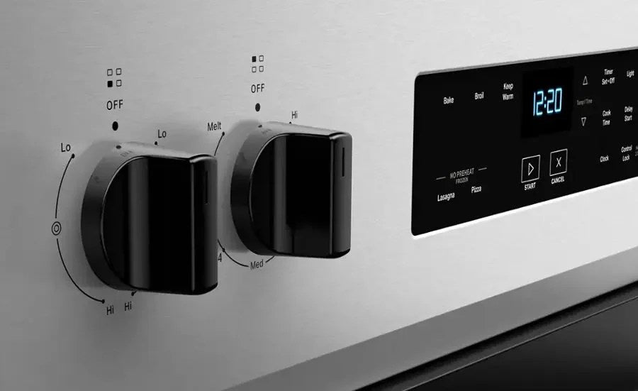 Whirlpool electric range with four burners and a digital control panel, stainless steel finish, and spacious oven interior.