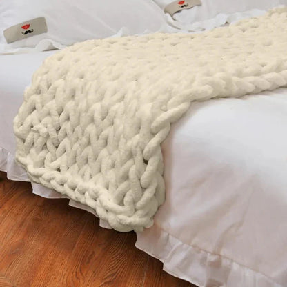 Belro chunky knitted chenille blanket with thick cable knit pattern, perfect for cozying up on a couch or bed in a home setting.