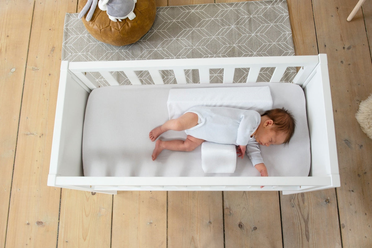Belro Baby Anti-Roll Wedge Pillow designed for safe sleep, featuring a soft, supportive pillow with a gentle incline for infants.