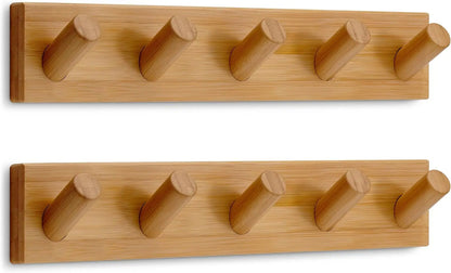 Wooden wall-mounted coat hook rack with five hooks, ideal for hanging jackets and coats in a home or office space.