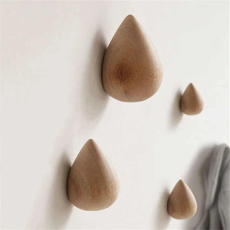 Belro beech wood water drop wall coat holder with multiple hooks for jackets and coats, mounted on a wall.