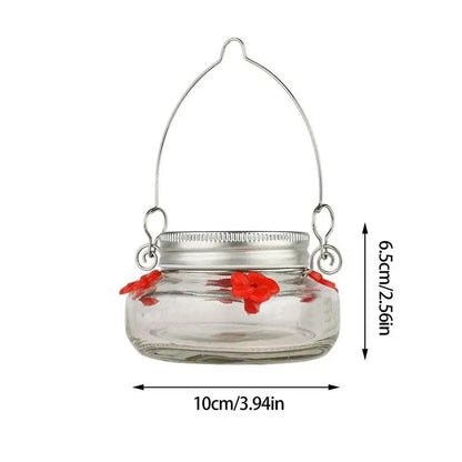 Clear flower port hummingbird feeder by Belro with vibrant flowers and hummingbird perched on the feeder in a garden setting.