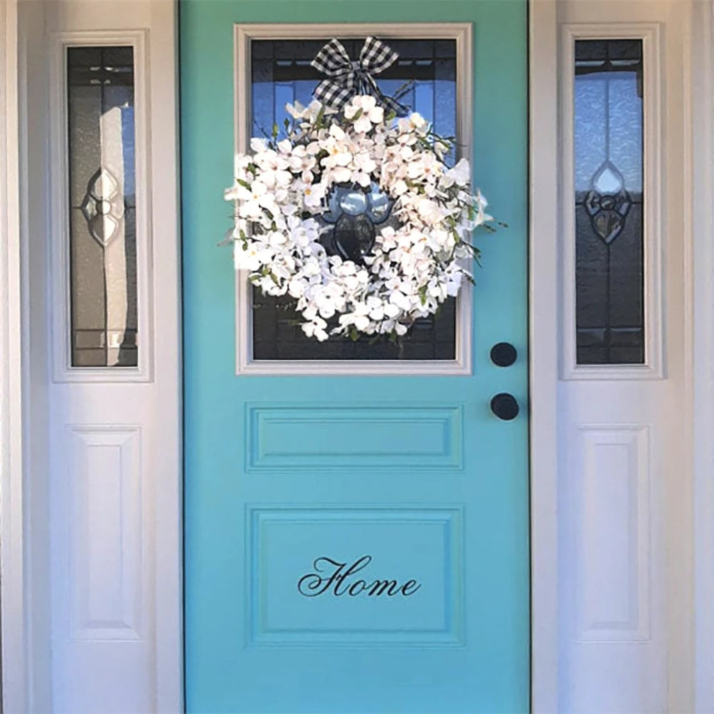 White dogwood flower wreath by Belro, decorative home and garden floral wall decor featuring delicate white blossoms.