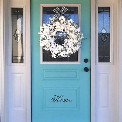 White dogwood flower wreath by Belro, decorative home and garden floral wall decor featuring delicate white blossoms.
