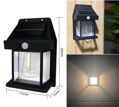 Pair of Mivoza solar wall lanterns with motion sensors, outdoor garden lighting, automatic on/off, mounted on a wall in a garden setting.