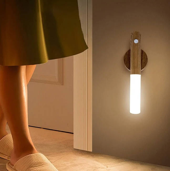 Belro plug-in motion sensor night light illuminating a bedroom wall, energy-efficient electronic lighting for nighttime visibility