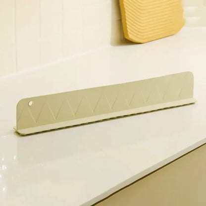 Belro silicone sink splash guard with suction cups, flexible kitchen appliance accessory to prevent water splashes.