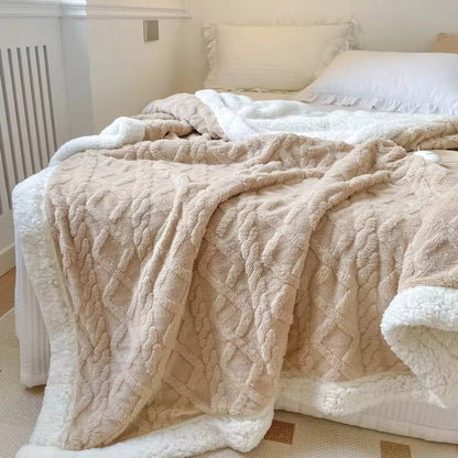 Belro men's fleece blanket draped over a chair, showcasing soft, cozy fabric in a neutral color.