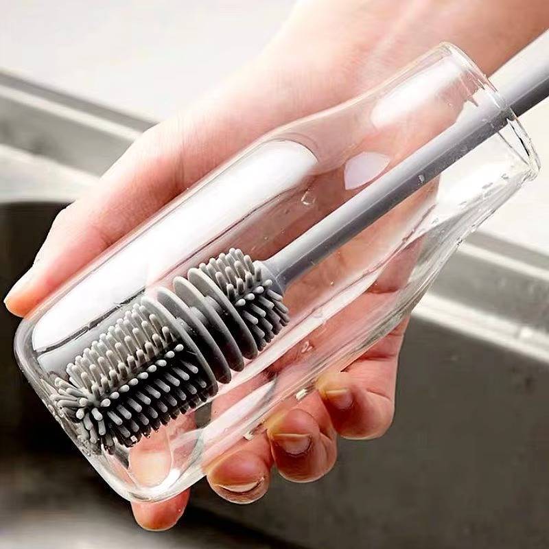 Belro bottle cleaning brush designed for footwear, shown cleaning the inside of a heel pump with a slim, flexible brush.