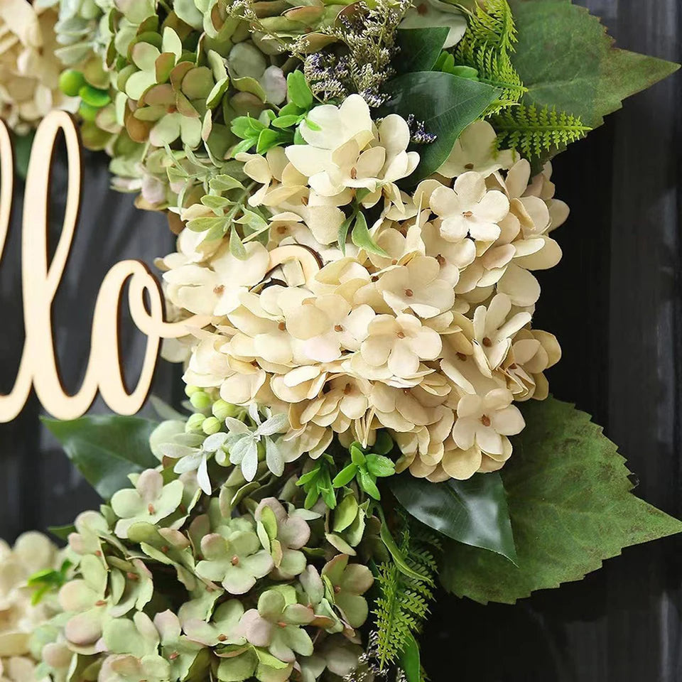 Green hydrangea wreath with a "Hello" sign hanging in a home décor setting, perfect for door or wall decoration.