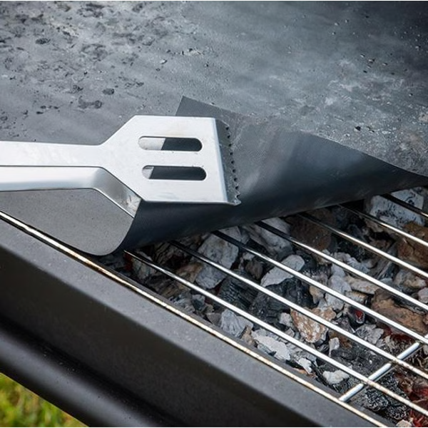 Belro chef non-stick BBQ grill mat laid out on a grill, perfect for preventing food sticking during outdoor cooking.