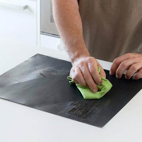 Belro Chef non-stick BBQ grill mat laid out on a grill, perfect for preventing food from sticking during outdoor grilling.