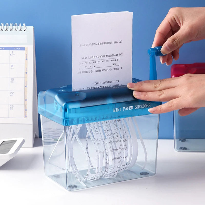Belro mini paper shredder for men, compact office device with shredding blades, shown on a desk with shredded paper.