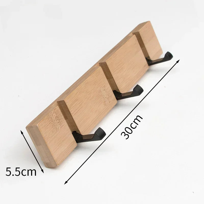 Wooden wall-mounted coat rack with hidden hooks by Belro, designed for hanging jackets and coats in a stylish home entryway.