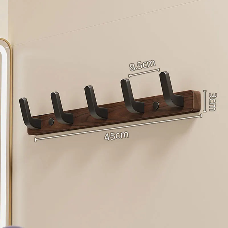 Minimalist Belro wall-mounted coat hook with wooden and metal design, holding jackets and coats on a clean wall.