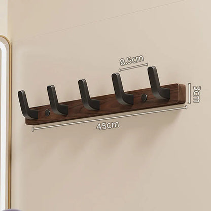 Minimalist Belro wall-mounted coat hook with wooden and metal design, holding jackets and coats on a clean wall.