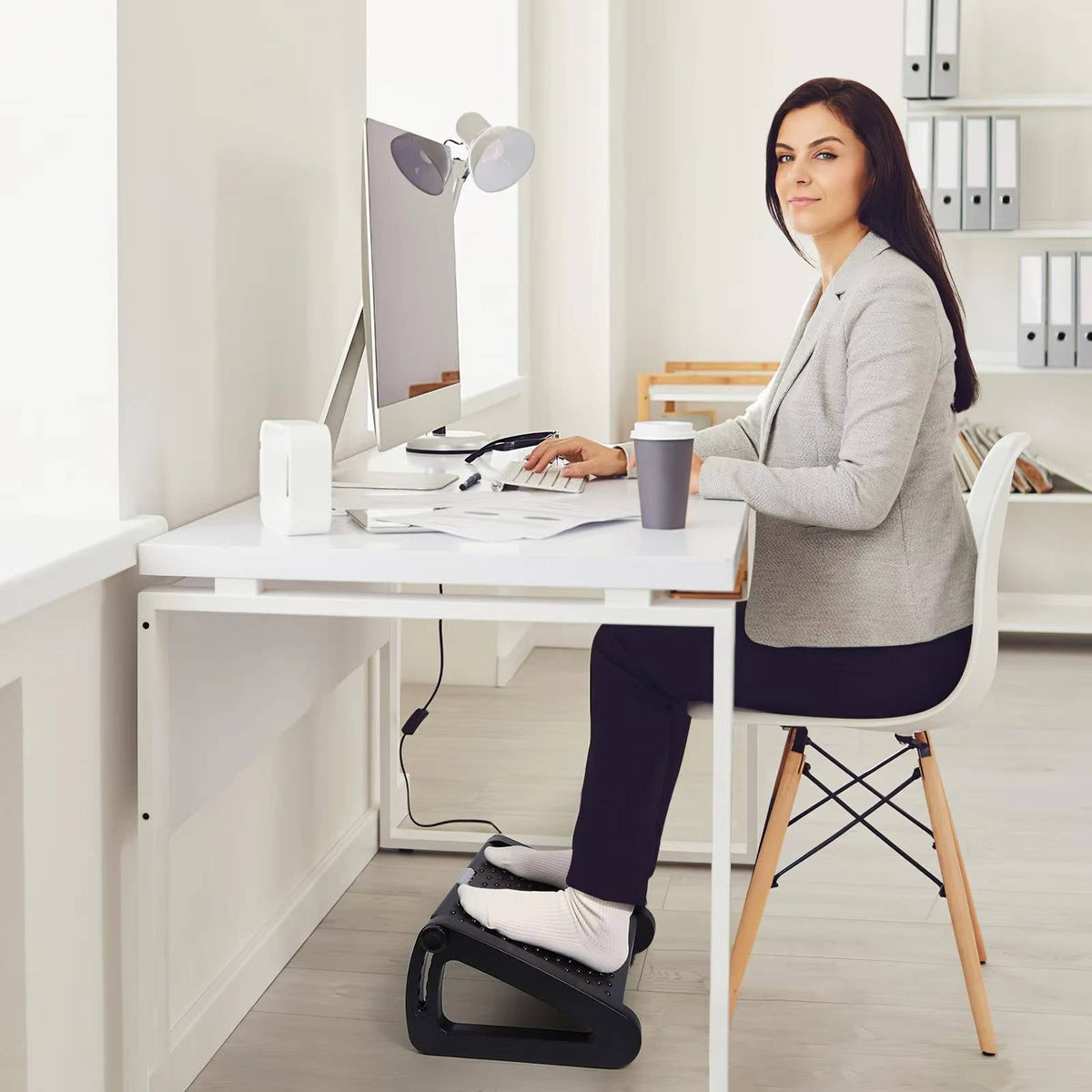 Belro under desk foot rest for ergonomic comfort, shown with cushioned surface and adjustable height for home office use.