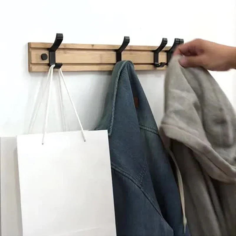 Wooden wall-mounted coat rack with sliding hooks for jackets and coats, branded Belro, shown hanging on a modern wall.