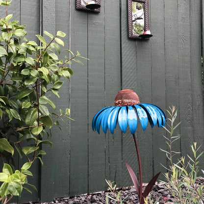 Belro outdoor flower bird feeder hanging from a garden branch with colorful flowers in the background