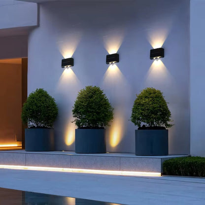 Belro energy-efficient LED solar outdoor wall light installed on a garden wall, providing eco-friendly illumination for home exterior.
