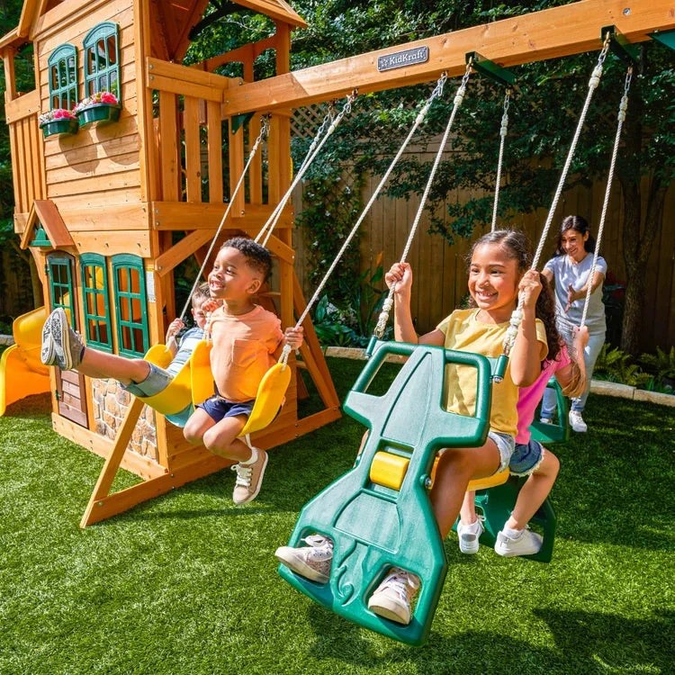 Casavibeo KidKraft Boulder Station Playset with climbing wall, slide, and swings in a colorful outdoor play area.