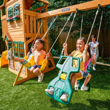 Casavibeo KidKraft Boulder Station Playset with climbing wall, slide, and swings in a colorful outdoor play area.