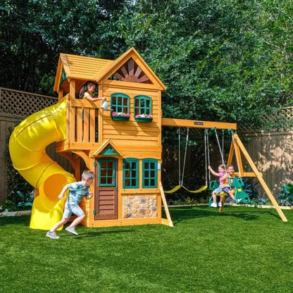 Casavibeo KidKraft Boulder Station Playset with climbing wall, slide, and playhouse in an outdoor backyard scene.