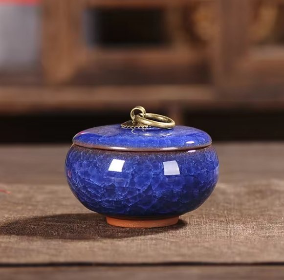 Handcrafted ceramic pet urn by BowLift featuring a smooth, rounded design with a paw print detail, suitable for dog and cat memorial keepsakes.
