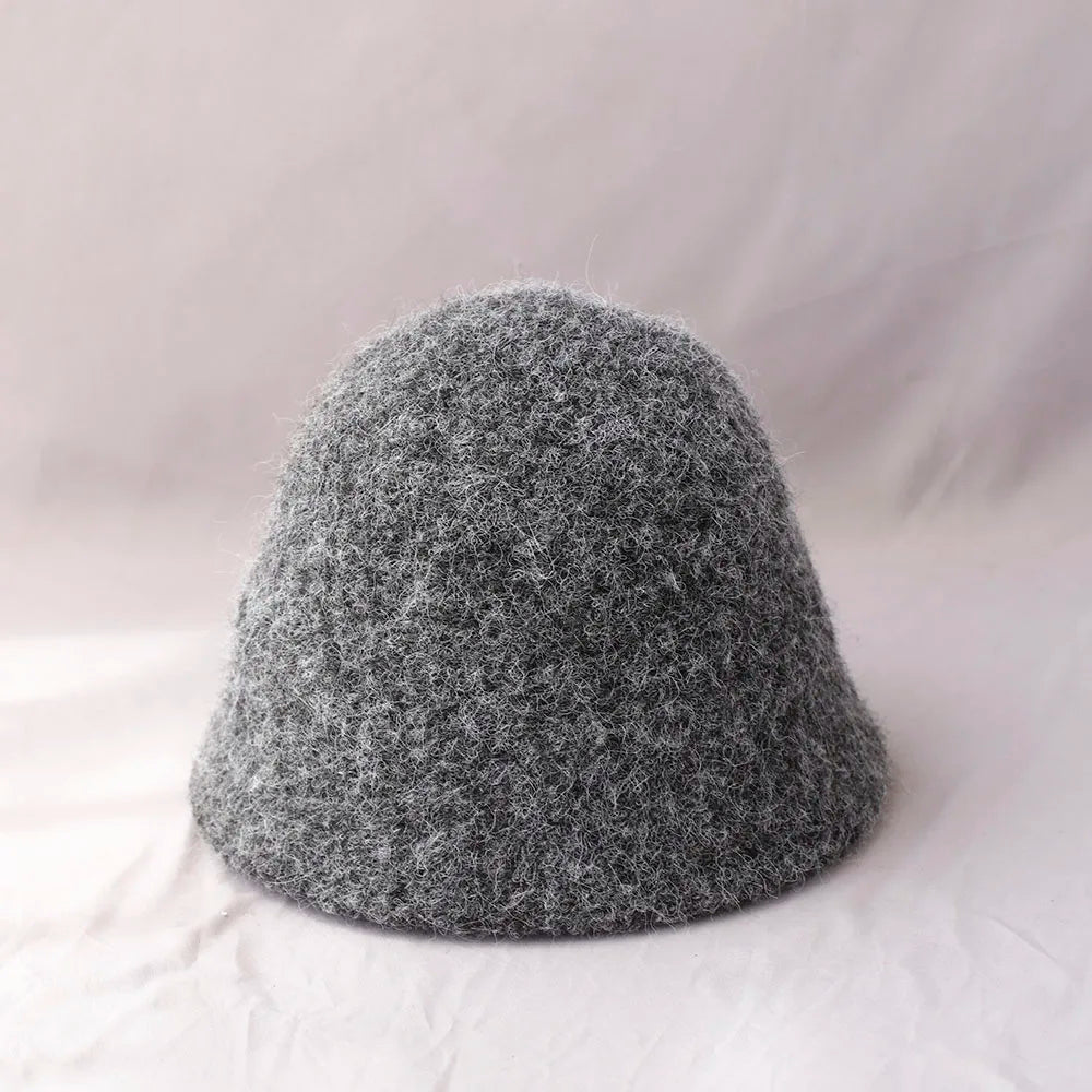 Gray women's winter wool bucket hat by Belro, cozy and stylish accessory for cold weather, with a soft knit texture.