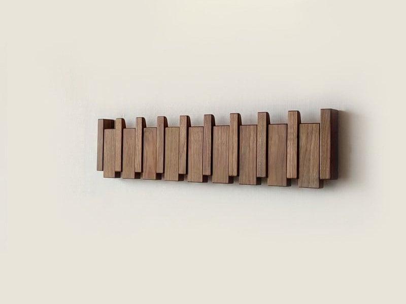 Handmade wooden coat rack with multiple hooks for jackets and coats, crafted by Belro, suitable for entryways and hallways.