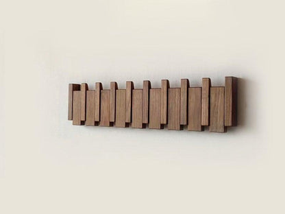 Handmade wooden coat rack with multiple hooks for jackets and coats, crafted by Belro, suitable for entryways and hallways.