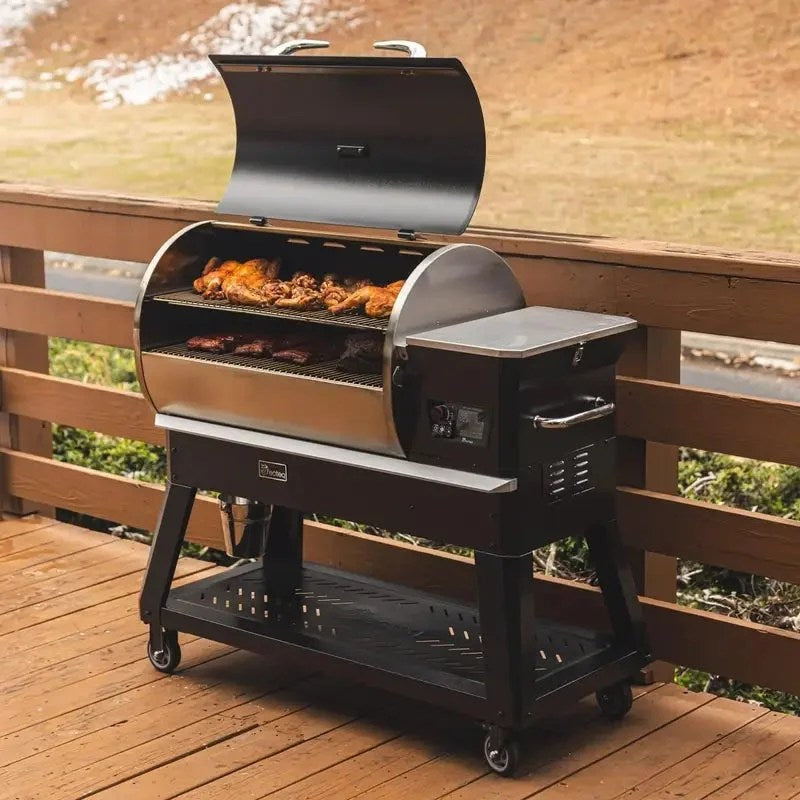 Casavibeo Recteq Backyard Beast pellet grill with stainless steel lid and control panel, set outdoors on a patio.