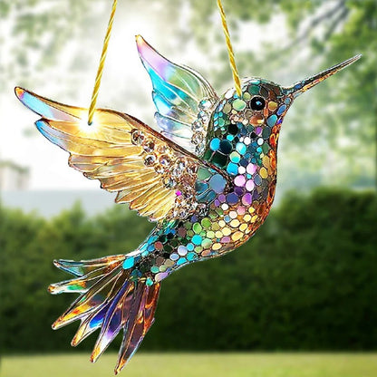 Colorful hummingbird suncatcher with reflective glass wings hanging in a garden outdoor decor by Belro.