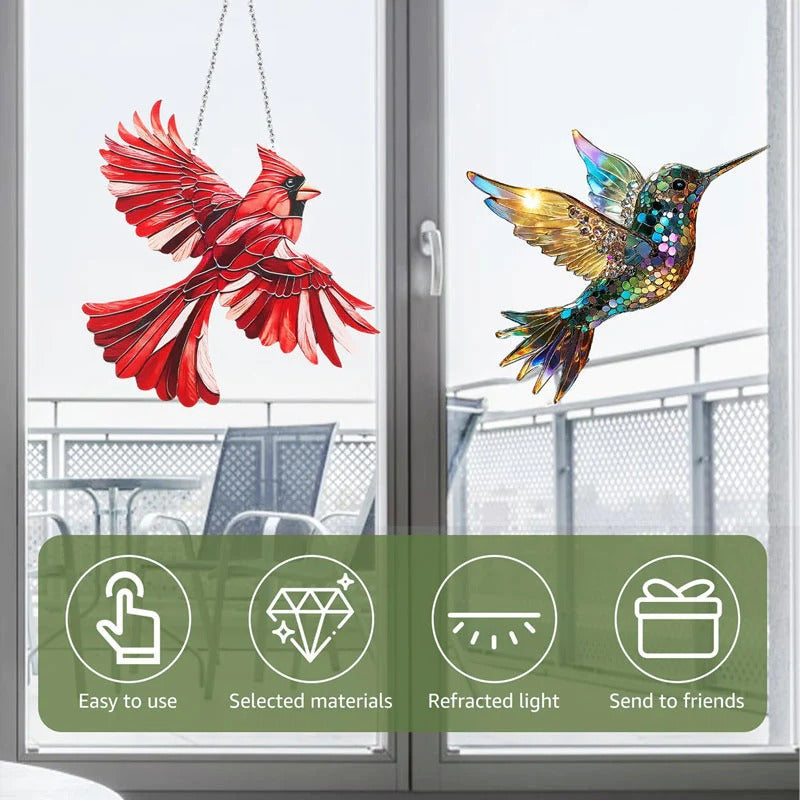 Colorful hummingbird suncatcher by Belro hanging outdoors with sunlight reflecting off its glass wings.