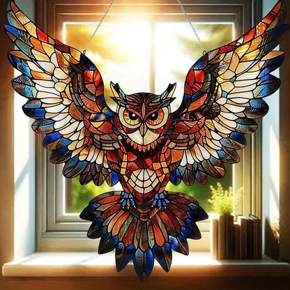 Colorful hummingbird suncatcher by Belro hanging in a garden, reflecting sunlight with vibrant glass wings and intricate design.