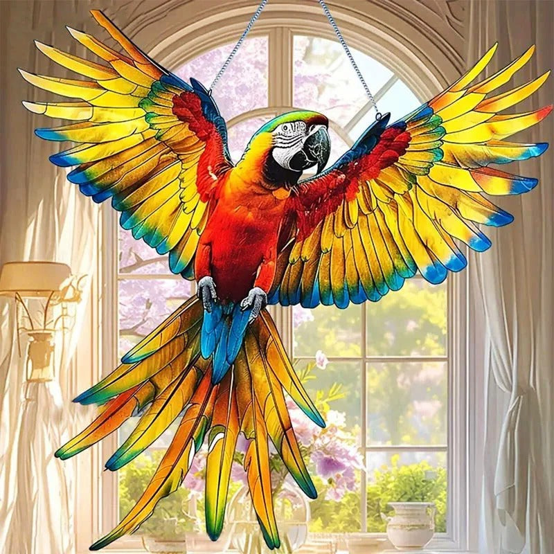Colorful hummingbird suncatcher from Belro, hanging in a garden, reflecting sunlight with vibrant glass details.
