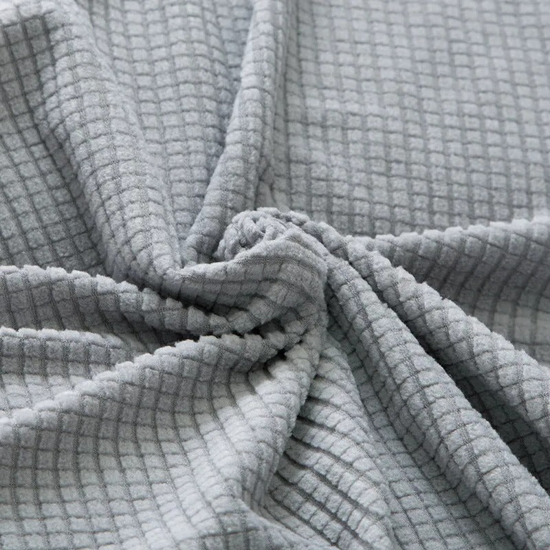 Belro stretchable sofa cover fitted on a modern sofa, protecting and enhancing the furniture in a home living room.