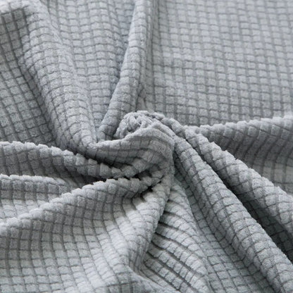 Belro stretchable sofa cover fitted on a modern sofa, protecting and enhancing the furniture in a home living room.