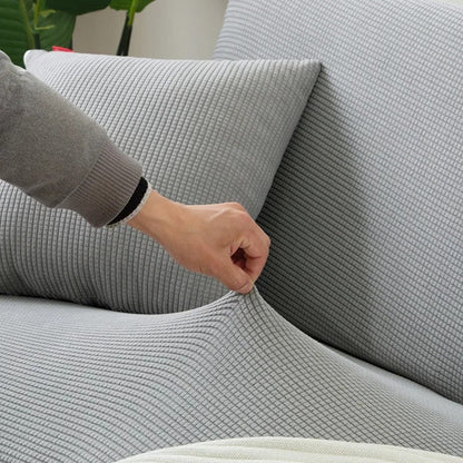Belro stretchable sofa cover fitted on a modern sofa, showcasing its elastic fabric for a snug, stylish furniture protection.