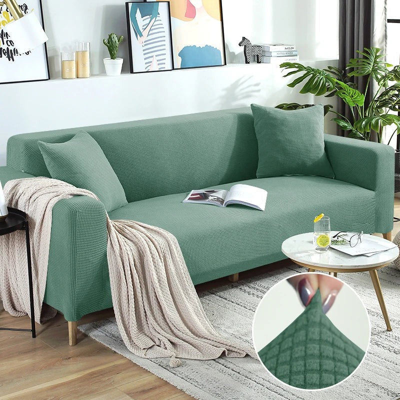 Stretchable Belro sofa cover draped over a modern living room sofa, protecting and enhancing furniture appearance.