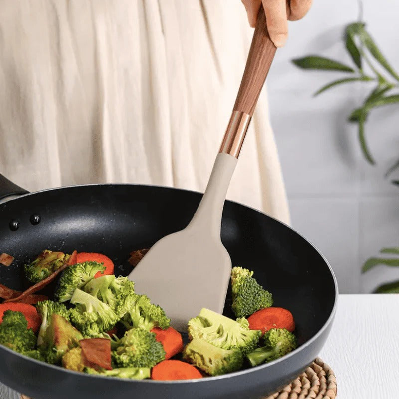 Belro kitchen utensil set with spatulas, spoons, and tongs arranged on a countertop, ideal for cooking and baking.