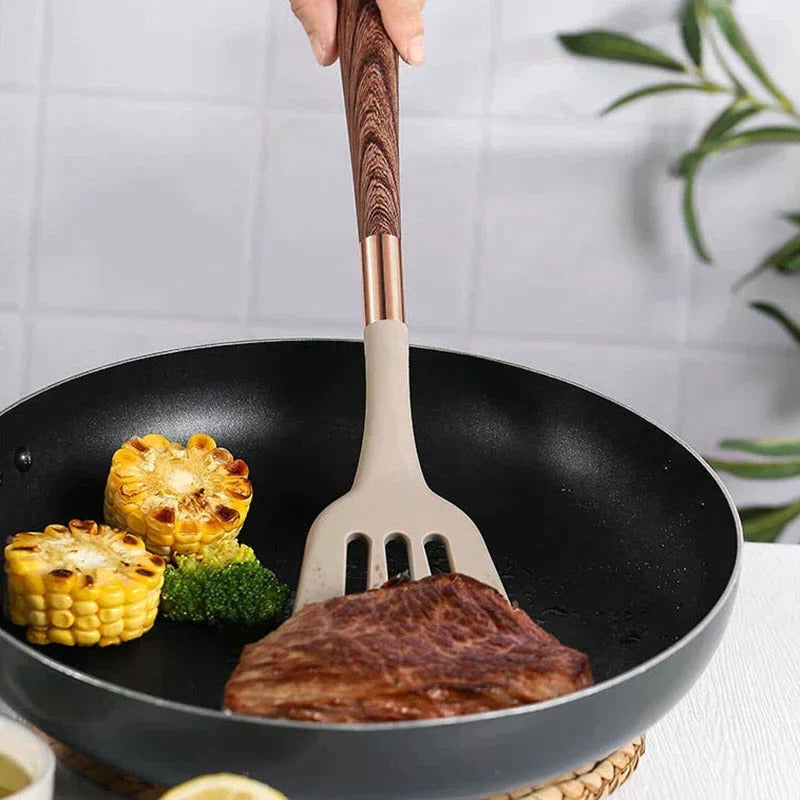 Belro kitchen utensil set featuring spatulas, spoons, and tongs arranged on a countertop for cooking and baking.