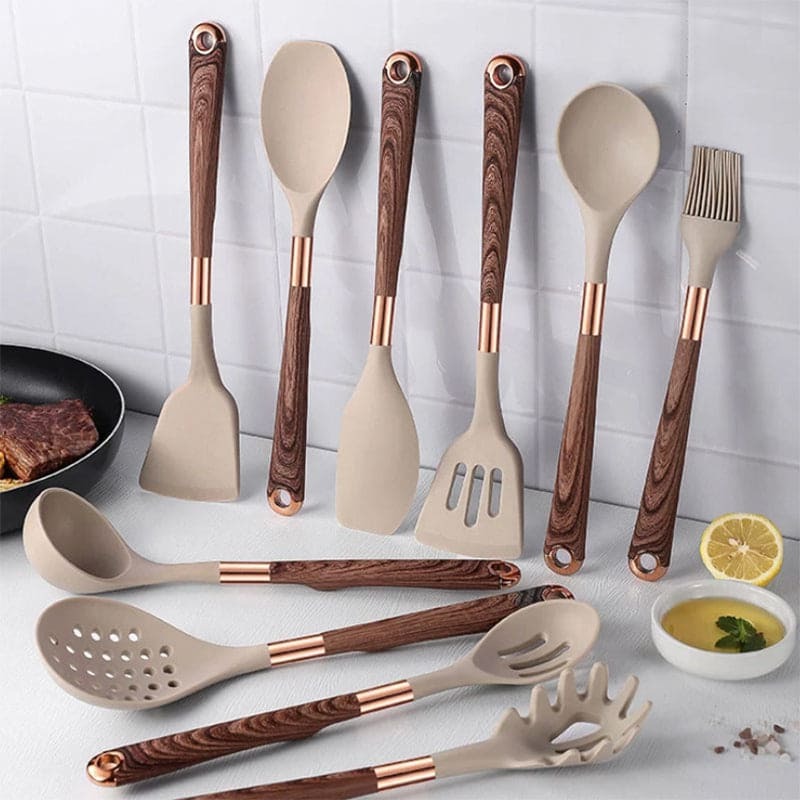 Belro kitchen utensil set with wooden handles, including spatulas, spoons, and tongs, arranged on a kitchen countertop.