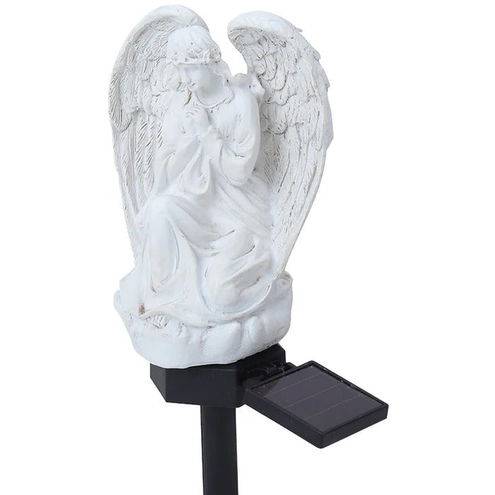 Belro Solar Angel Garden Light illuminating a garden at dusk, decorative outdoor night light with solar-powered illumination